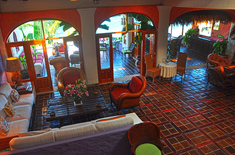 The wondrous 40' living room with ceiling 18 feet high, open and wide to take advantage of the gentle Pacific breezes. Underfoot, the floors are hand-crafted tiles set into surrounds of iron wood.