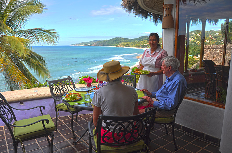 The charming dining room is circular and enclosed in glass to take full advantage of the superb views over the Pacific and the cone ceiling, unique in design, is covered in native royal palm; the seating cozily accommodates 10 Guests.